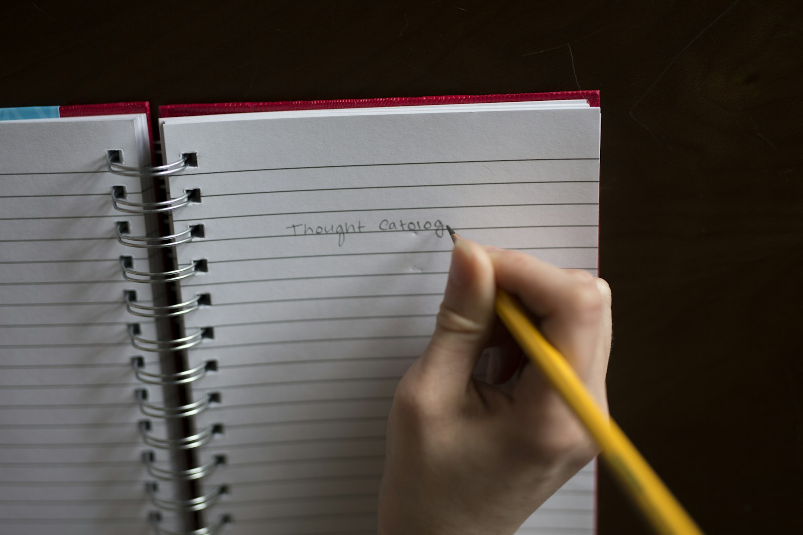 Student writing at a desk